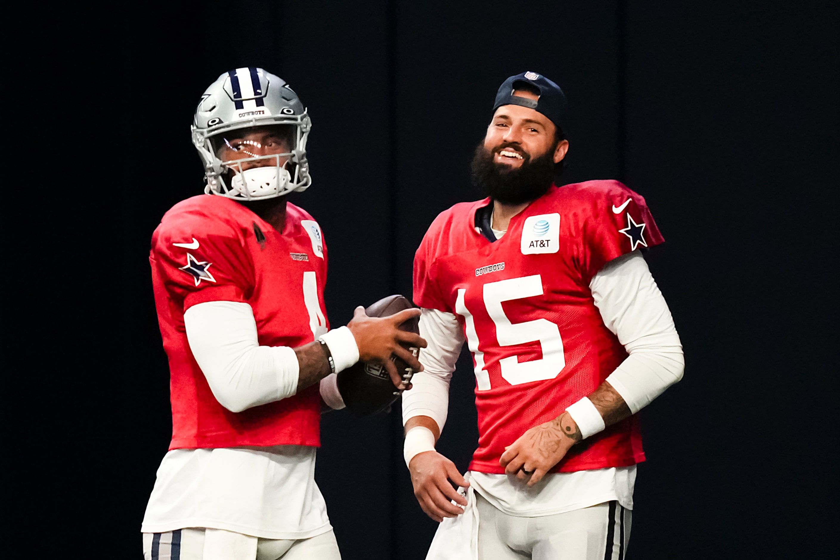 Dallas Cowboys quarterback Dak Prescott (4) laughs with quarterback Will Grier (15) during...