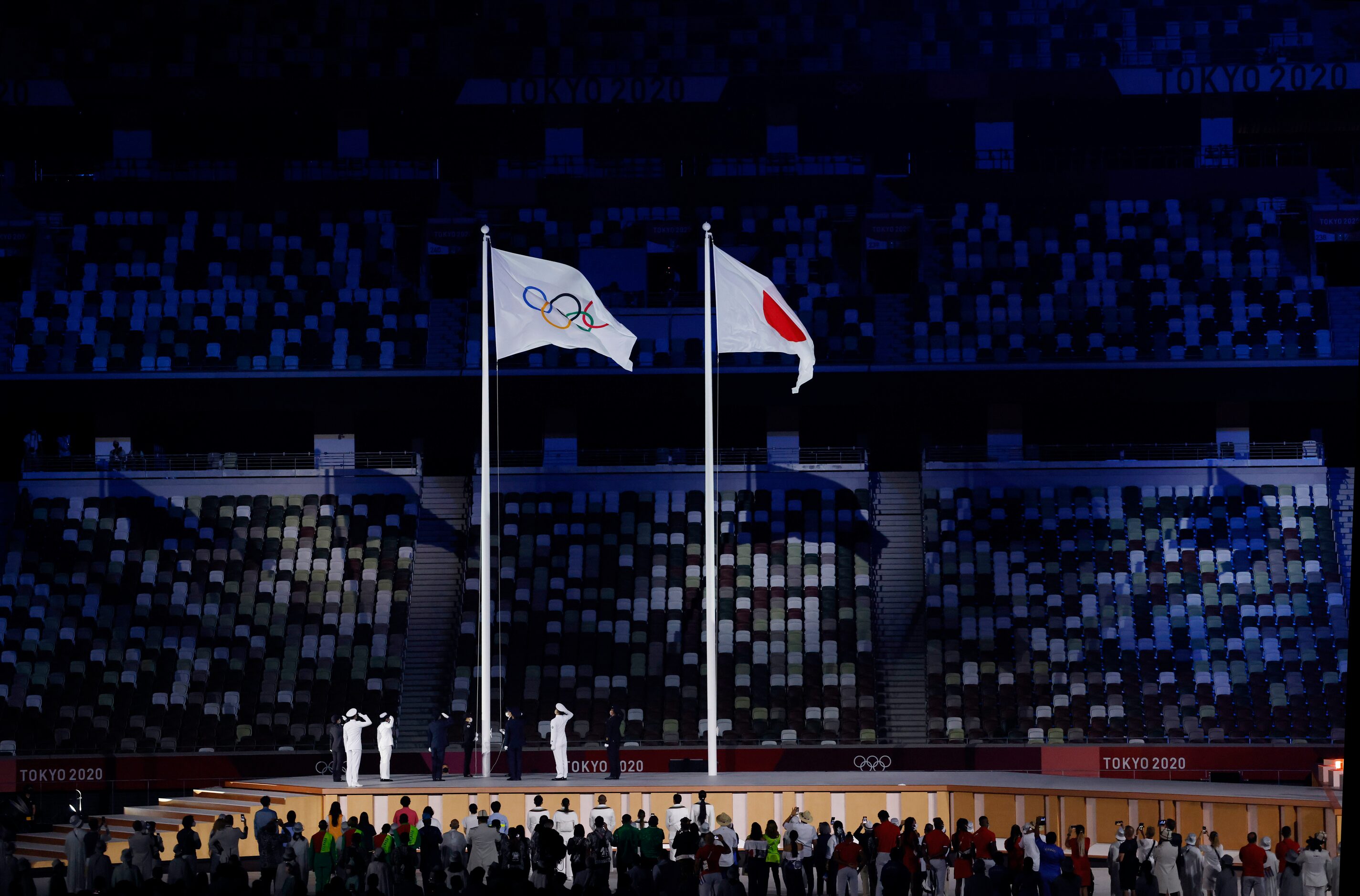 The Olympic flag is raised during opening ceremony for the postponed 2020 Tokyo Olympics at...