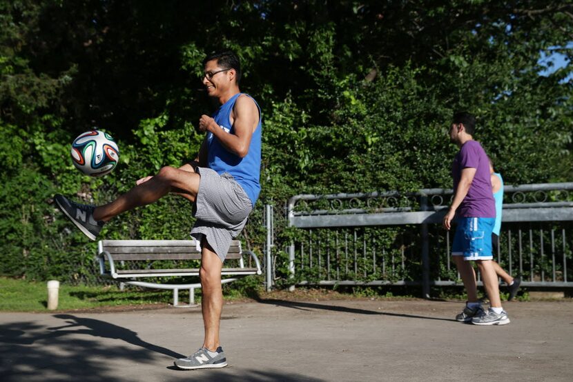  Jose Vazquez, of Dallas, kicks a soccer ball on the Katy Trail near the Katy Trail Ice...