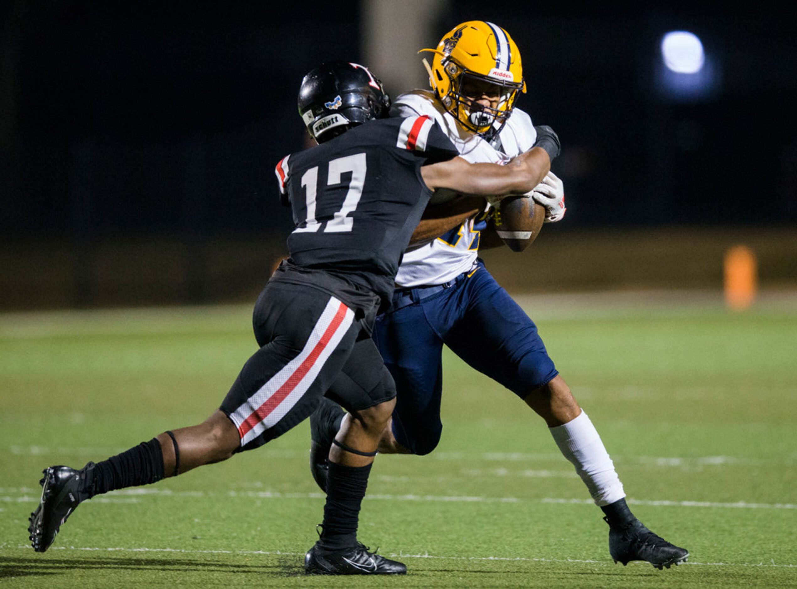 Arlington Lamar running back Caleb Phillips (14) is tackled by Euless Trinity defensive back...