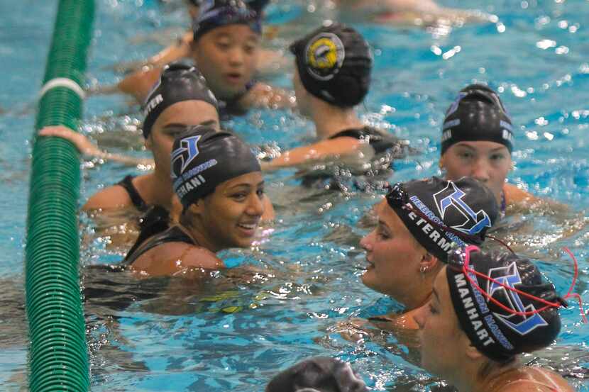 Riya Meghani, center left, sports a smile as she and other teammates hit the water for an...