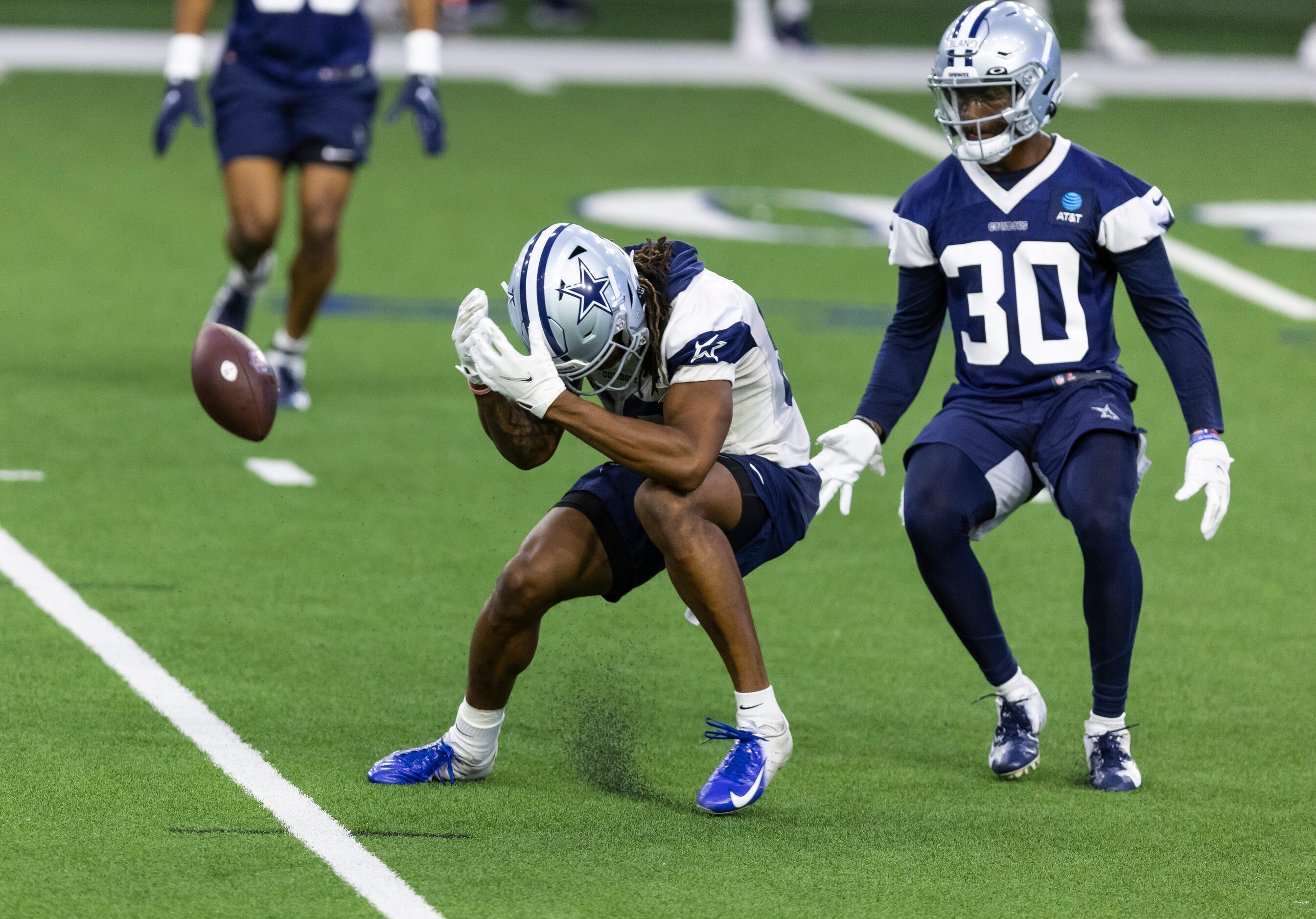 Dallas Cowboys cornerback DaRon Bland (30) looks on after wide receiver Brandon Smith, left,...