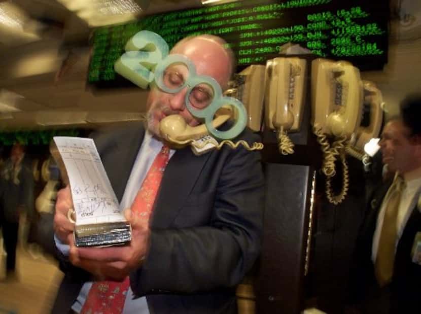 ORG XMIT: S12CCC5B6_WIRE Broker Peter Tuchman wears '2000' glasses as he uses a phone post...