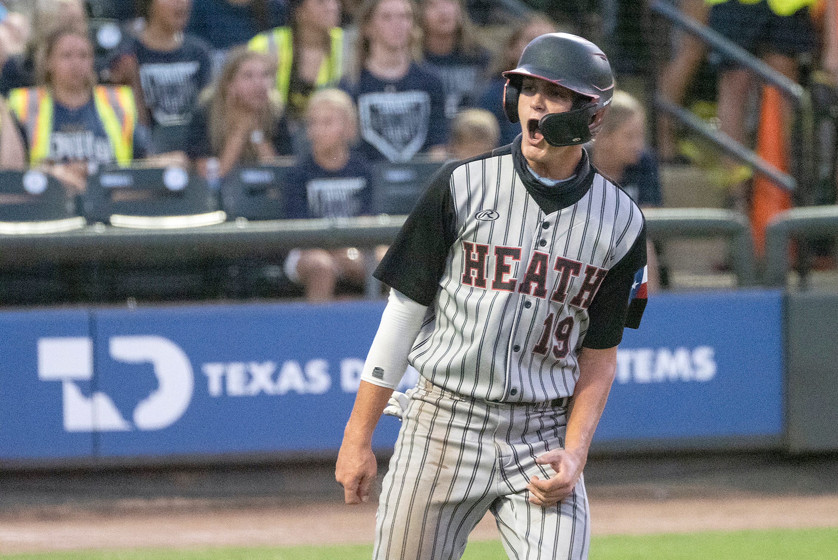 Rockwell-Heath Johnny Lowe, (19), celebrates scoring a run against Comal Smithson Valley...