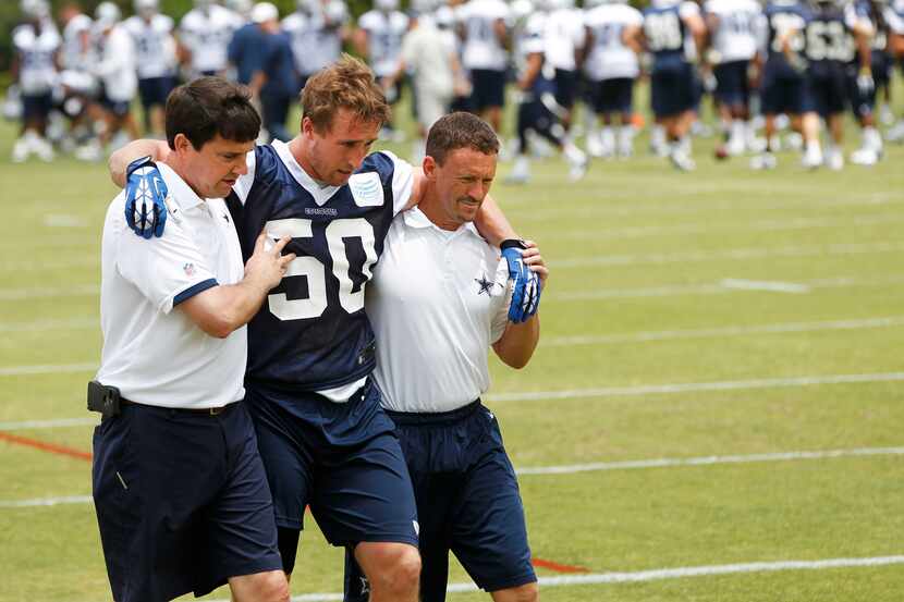 Cowboys lineback Sean Lee is helped off the field after injuring his knee May 27. (File photo)