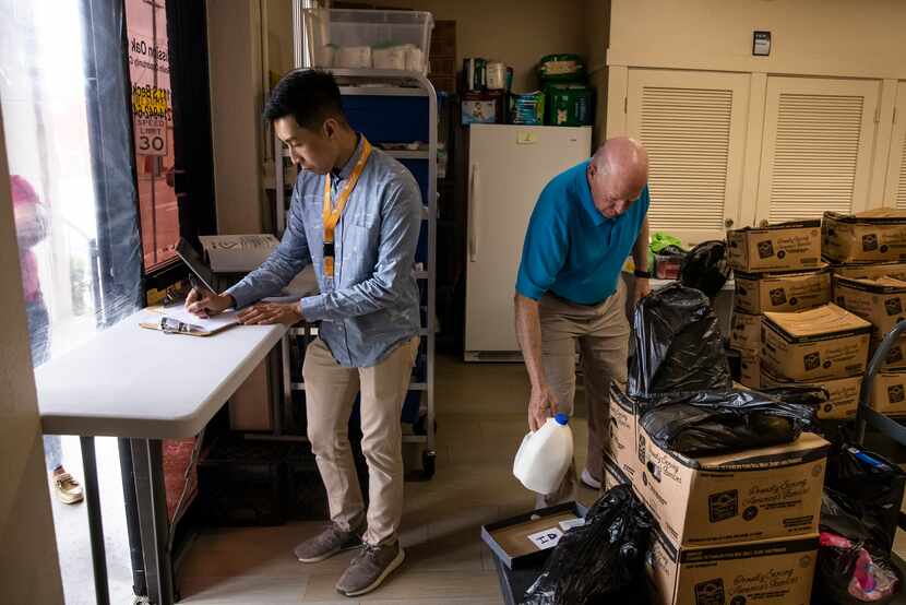 Mission Oak Cliff executive director Kevin Pranoto (left) and volunteer Billy Leftwich...