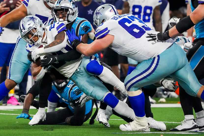 Dallas Cowboys running back Tony Pollard (20) picks up a first down as he is brought down by...