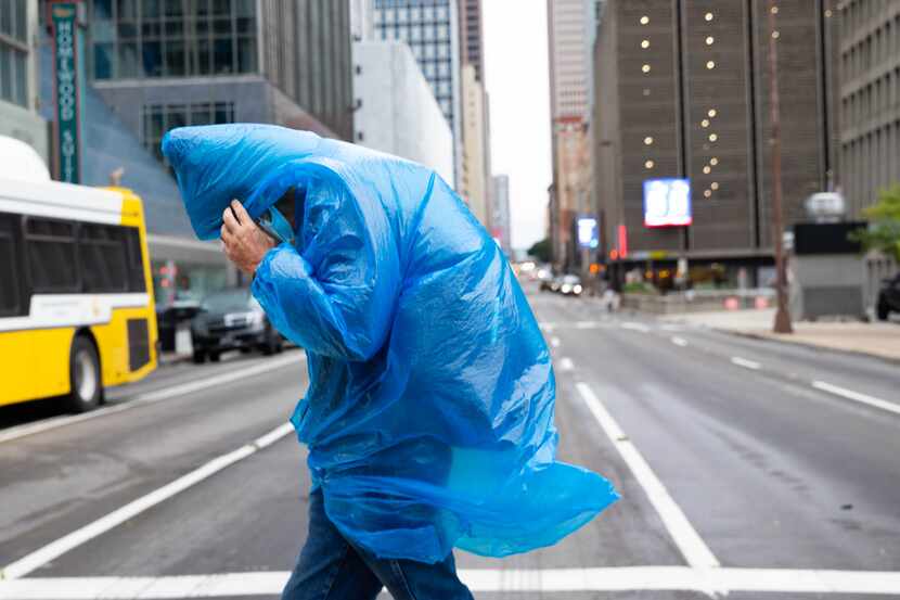 Ken Williams shielded his face from the chilly wind as he walked in downtown Dallas on Oct....