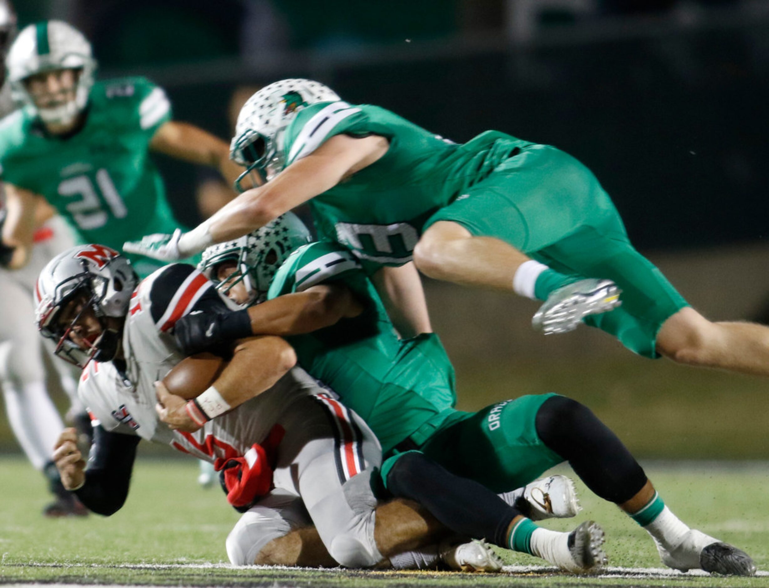 Flower Mound Marcus quarterback Xavier Maxwell (15) is tackled by Southlake Carroll...