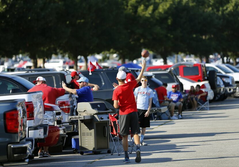 Texas Rangers fans played catch with a football in the parking lot before the ALDS Series...