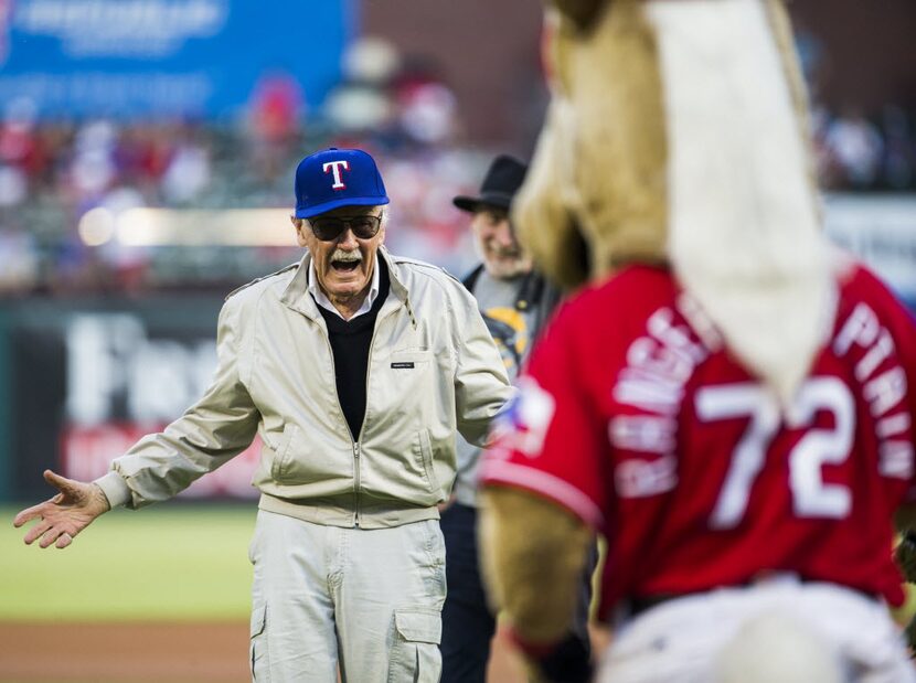 Former president and CEO of Marvel Comics Stan Lee greets the Texas Rangers mascot, Captain,...