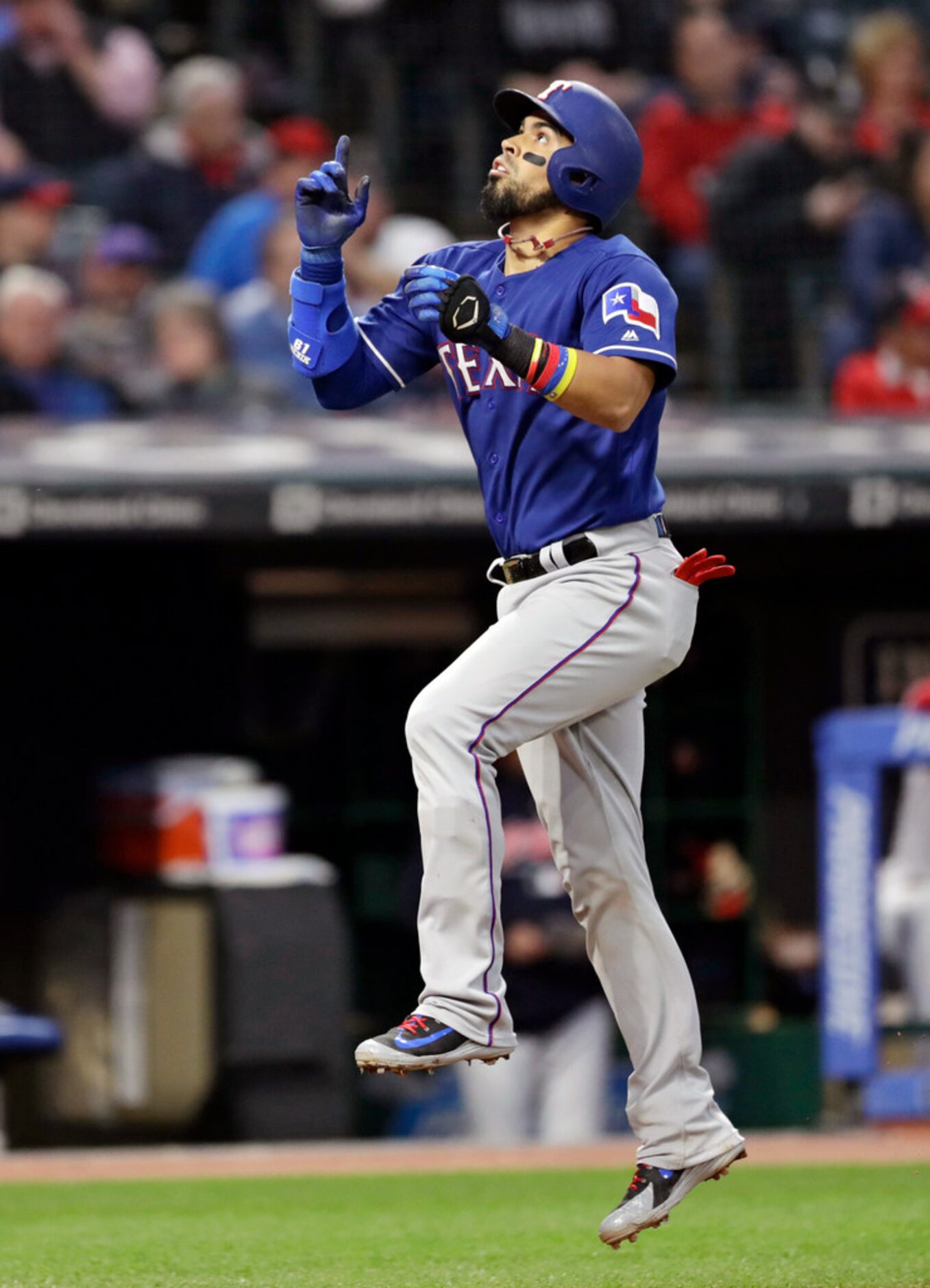 Texas Rangers' Robinson Chirinos celebrates as he runs the bases after hitting a solo home...