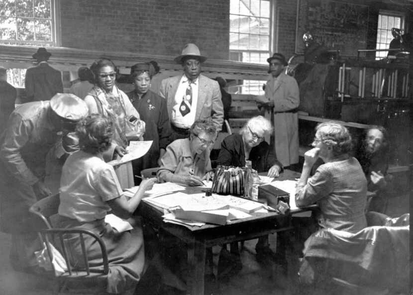 Voters cast ballots at a polling station in a Little Rock firehouse in November 1957, after...