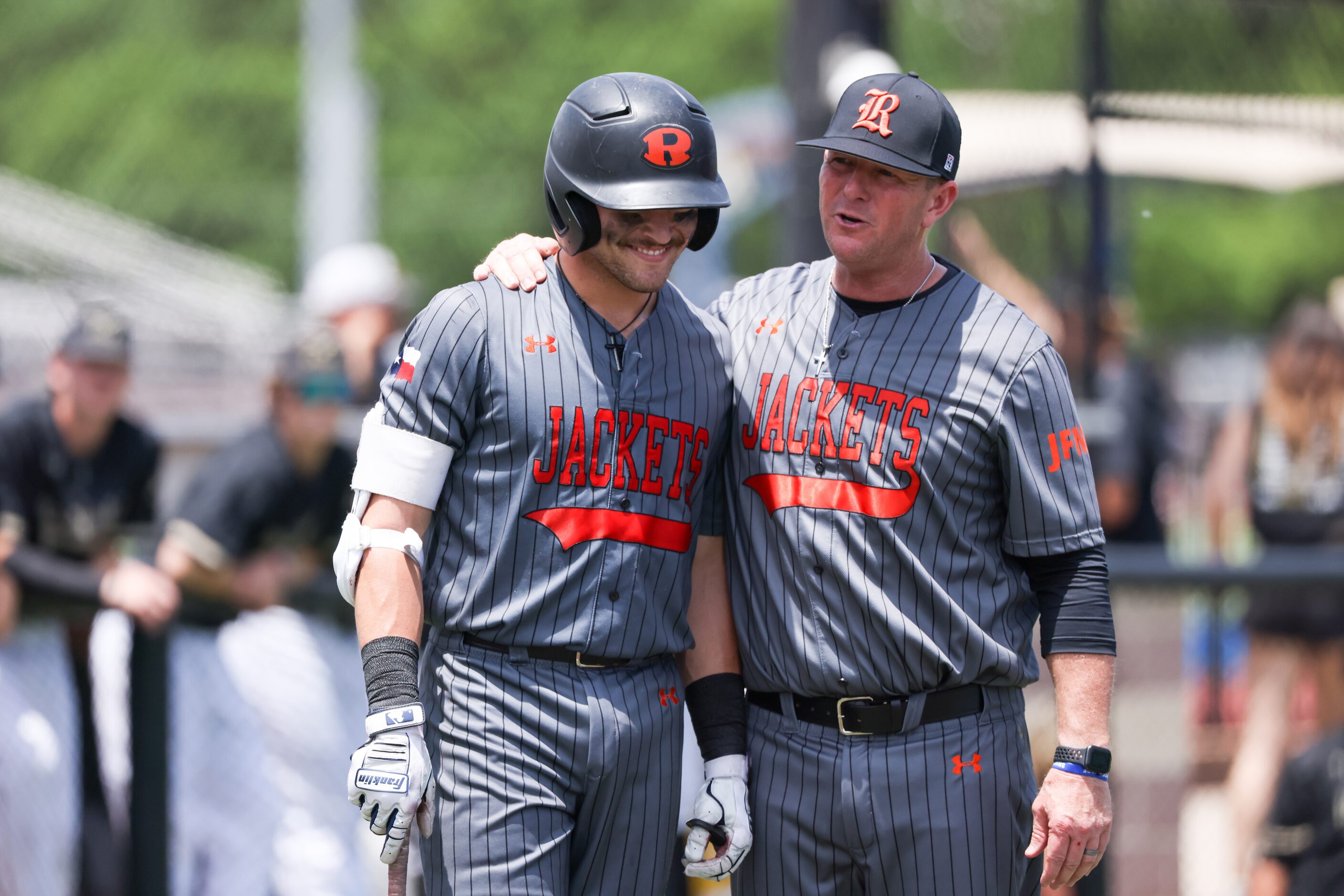 Rockwall senior Mac Rose (left) speaks with head coach Barry Rose (right) between times at...