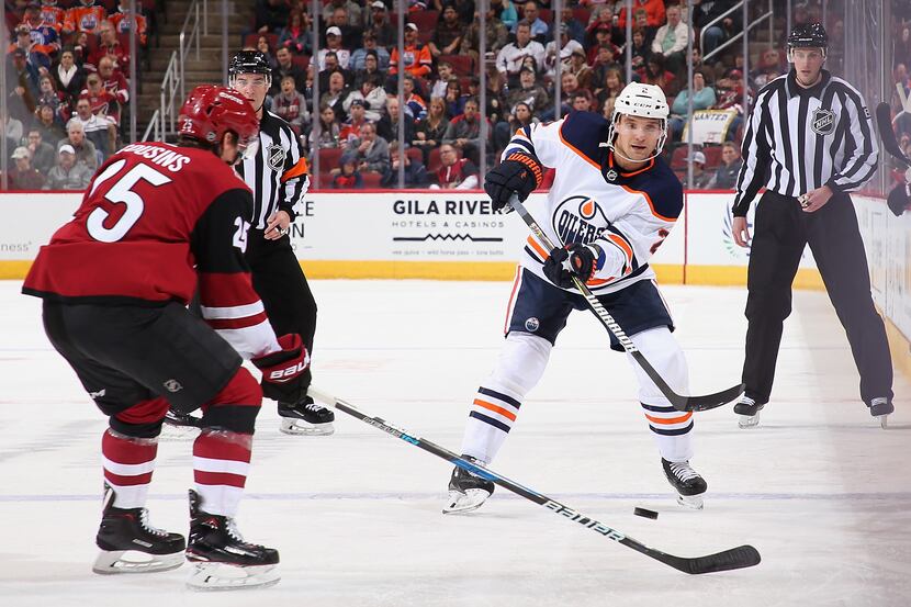 GLENDALE, AZ - JANUARY 12:  Andrej Sekera #2 of the Edmonton Oilers passes the puck around...