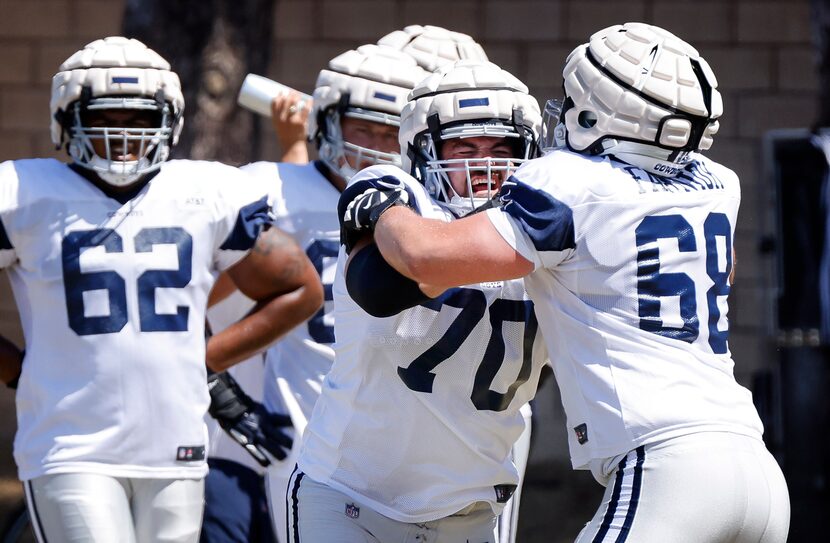 Dallas Cowboys guard Matt Farniok (68) and guard Zack Martin (70) work on blocking during...