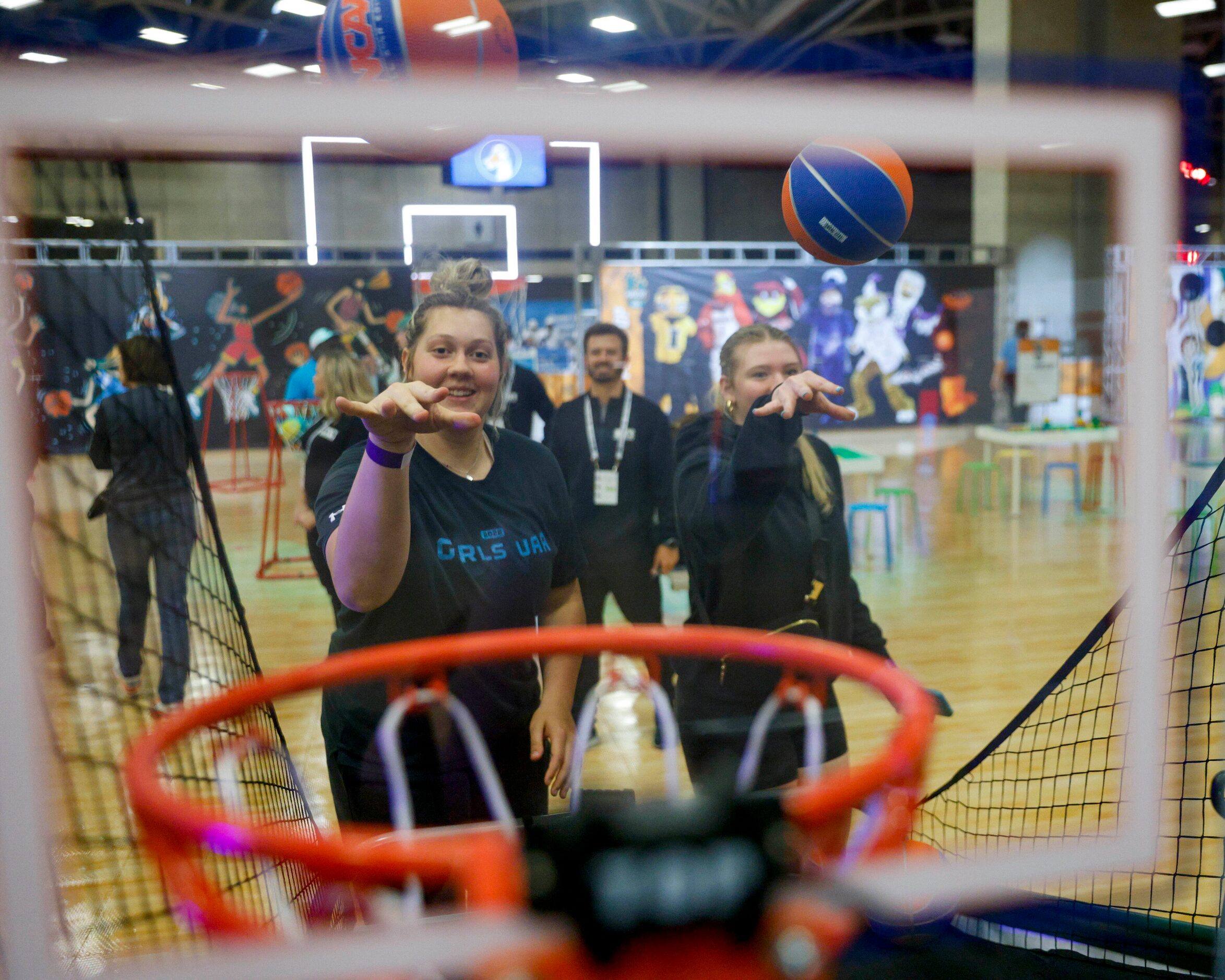 Faith Acker, 17, and Grace Grocholski, 17, compete against each other in a basketball game...