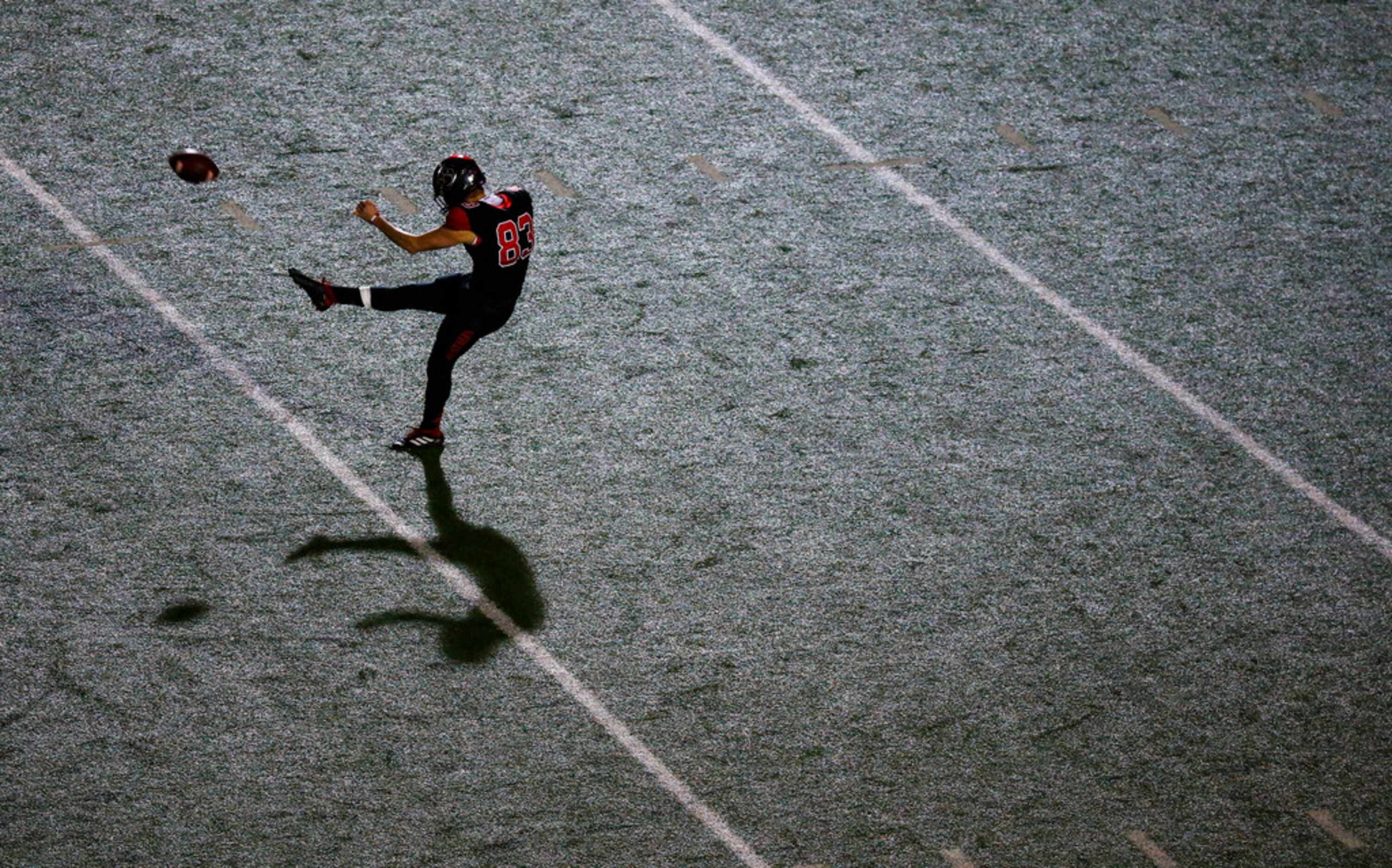 Colleyville Heritage punter Chase Allen (83) sends the ball airborne during the second...