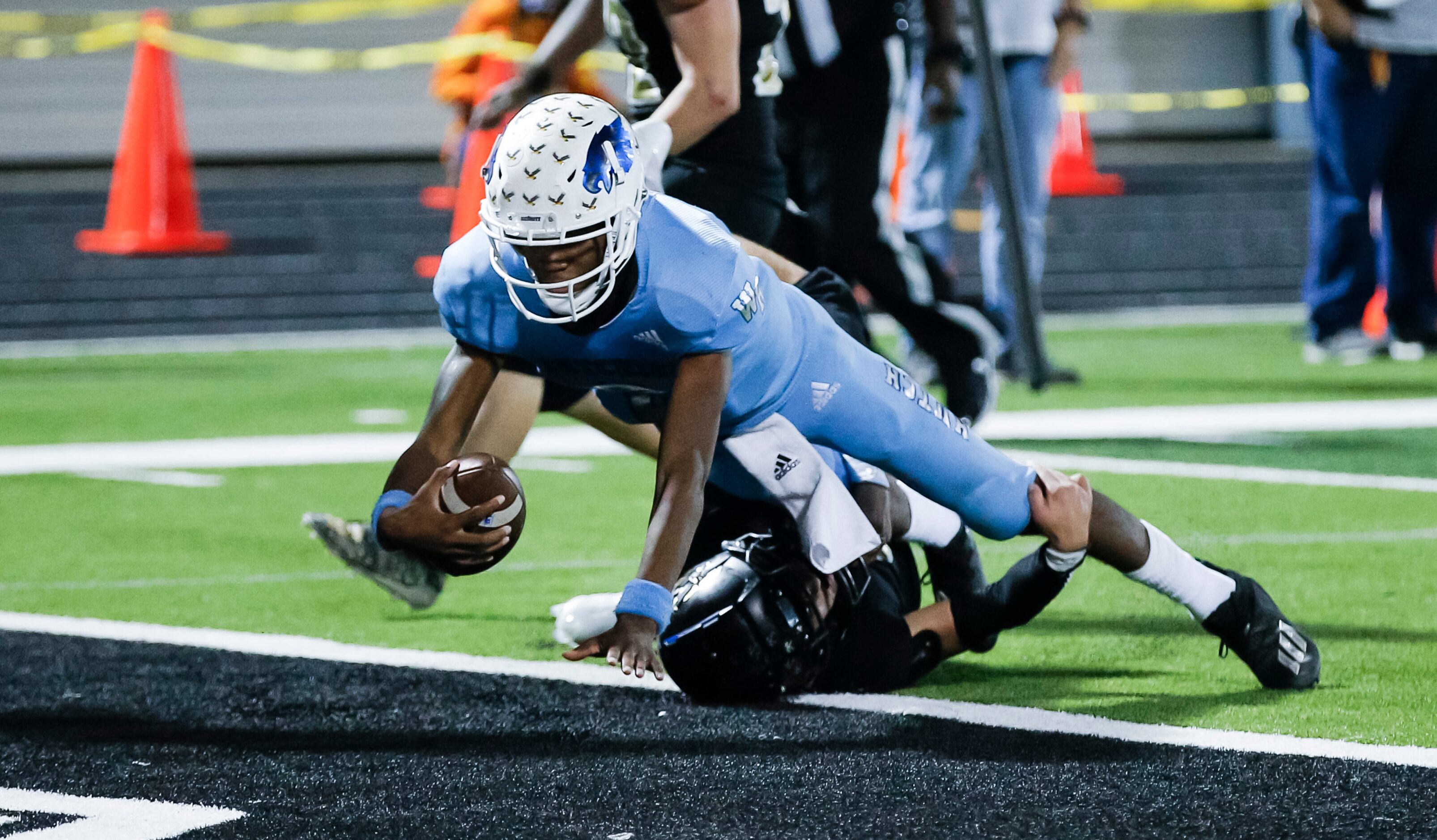 Wilmer-Hutchins senior quarterback Andre Henderson (2) scores the winning touchdown during...