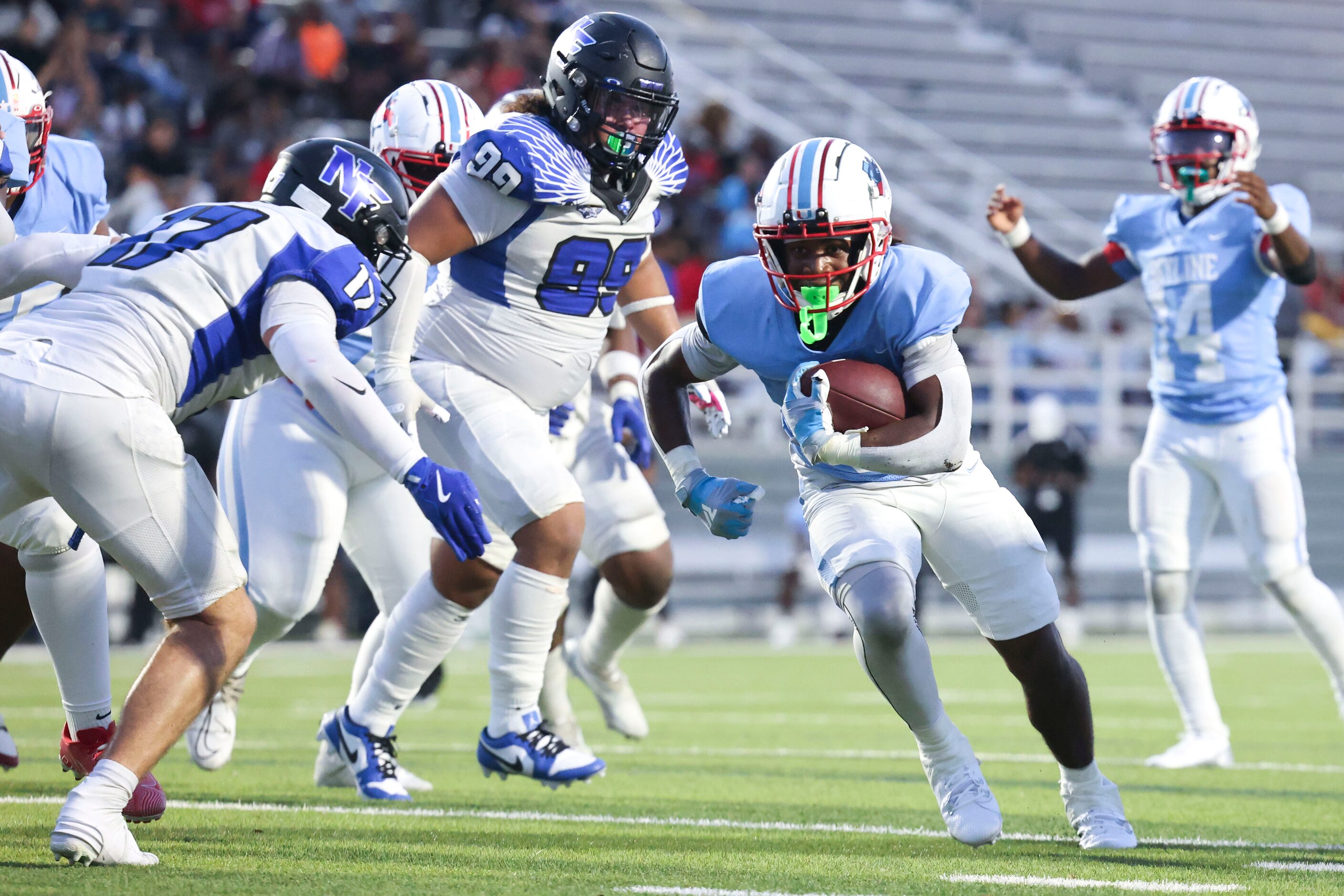 Skyline High’s quarterback Donte Ware (center) runs to the end zone for a touchdown during...