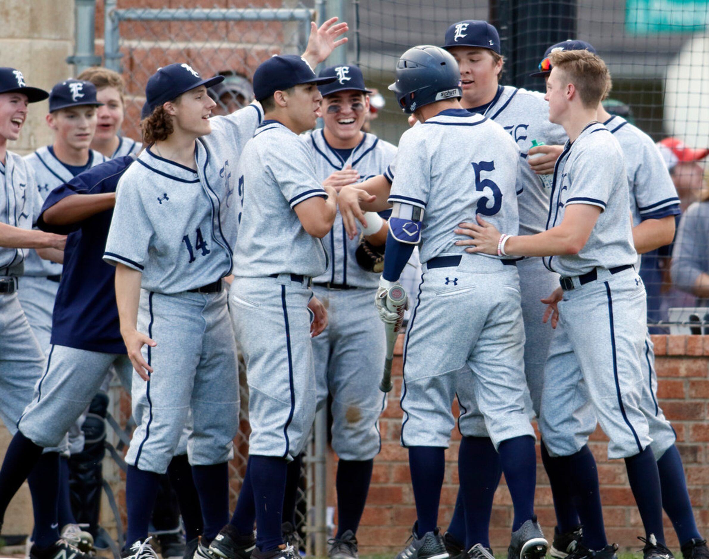 Northwest Eaton's Sean Klein (5) receives congratulations from teammates after scoring from...