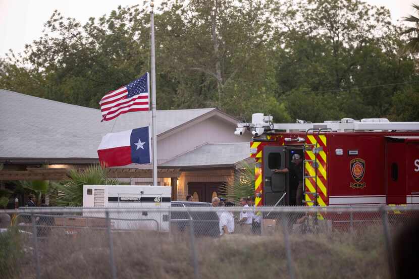 Flags fly at half-staff outside of Robb Elementary School after 14 children and one teacher...
