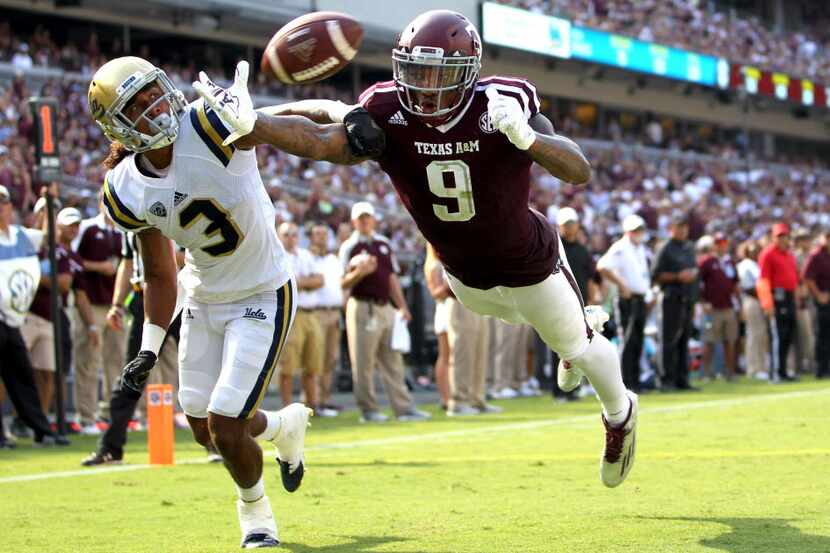 Texas A&M wide receiver Ricky Seals-Jones (9) and UCLA's defensive back Randall Goforth (3)...