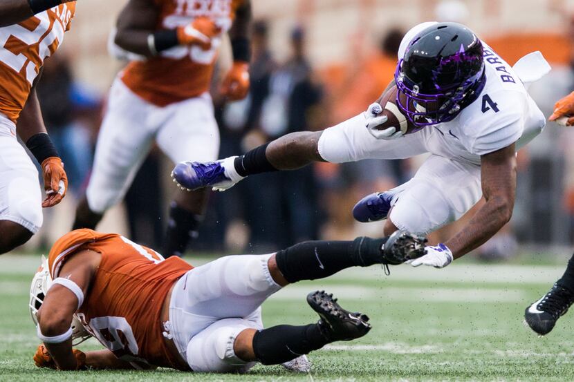 FILE - TCU Horned Frogs wide receiver Taye Barber (4) is tripped up by Texas Longhorns...