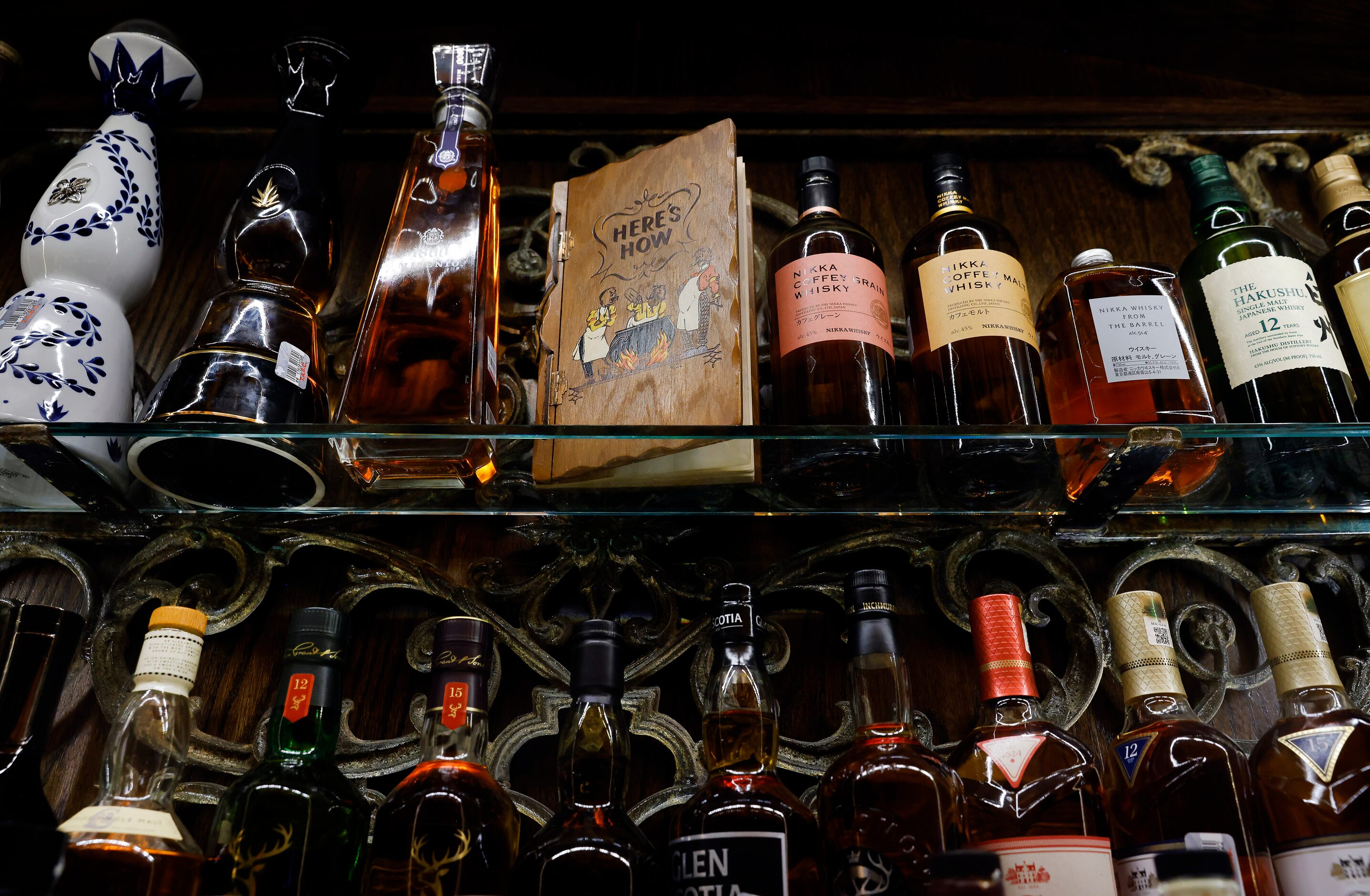 The Here’s How book sits atop the bar shelves during a press event at Red Phone Booth, a...