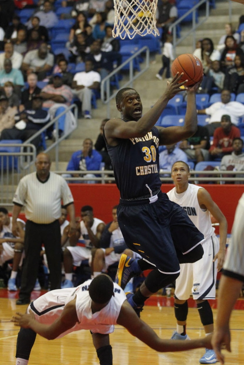 Prestonwood's Julius Randle (30) draws a foul from Madison Prep Academy's Darell Martin (22)...