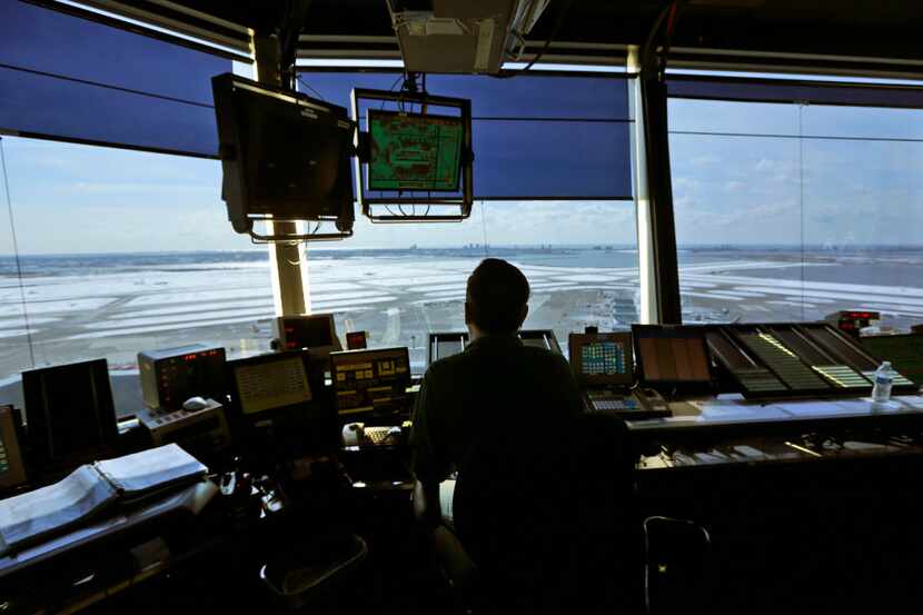 An air traffic controller works in the tower at John F. Kennedy International Airport in New...