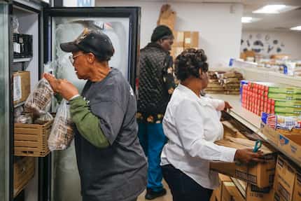 Shirley McGhee (left), Gladys Coleman, and Betty Rayson stock food pantry shelves at Harmony...