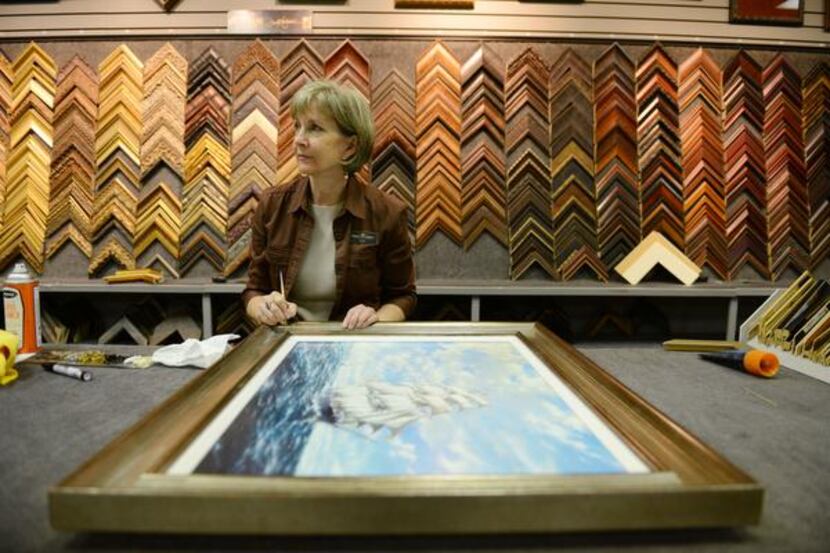 Designer Gwen Bell cleans a frame at the Dutch Art Gallery in Lake Highlands. 