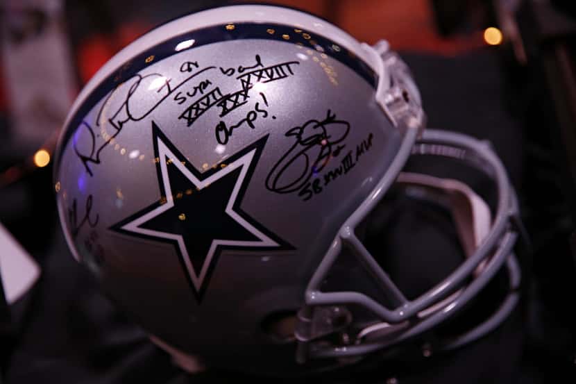 A Dallas Cowboys helmet signed by former players Troy Aikman, Michael Irving and Emmitt...