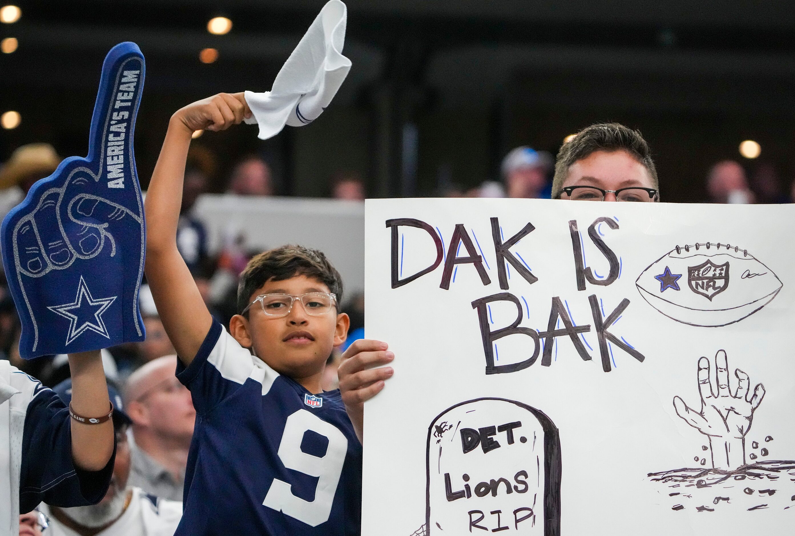 Dallas Cowboys fans cheer quarterback Dak Prescott during the third quarter of an NFL...