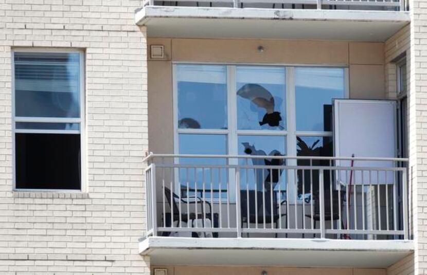 
Bullet holes shattered windows at the Vista Apartments.
