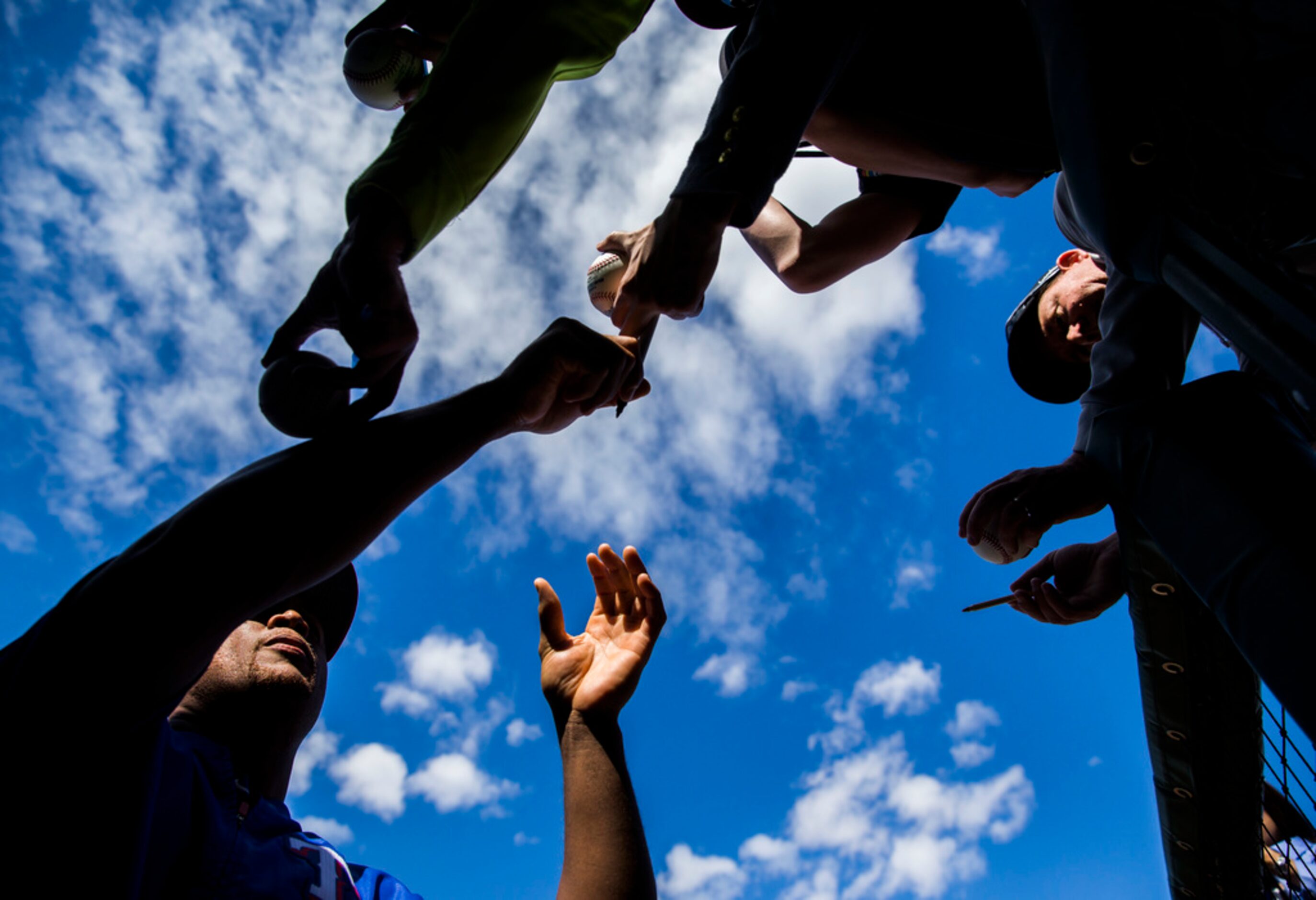 Texas Rangers third baseman Adrian Beltre (29) signs autographs for fans during a spring...