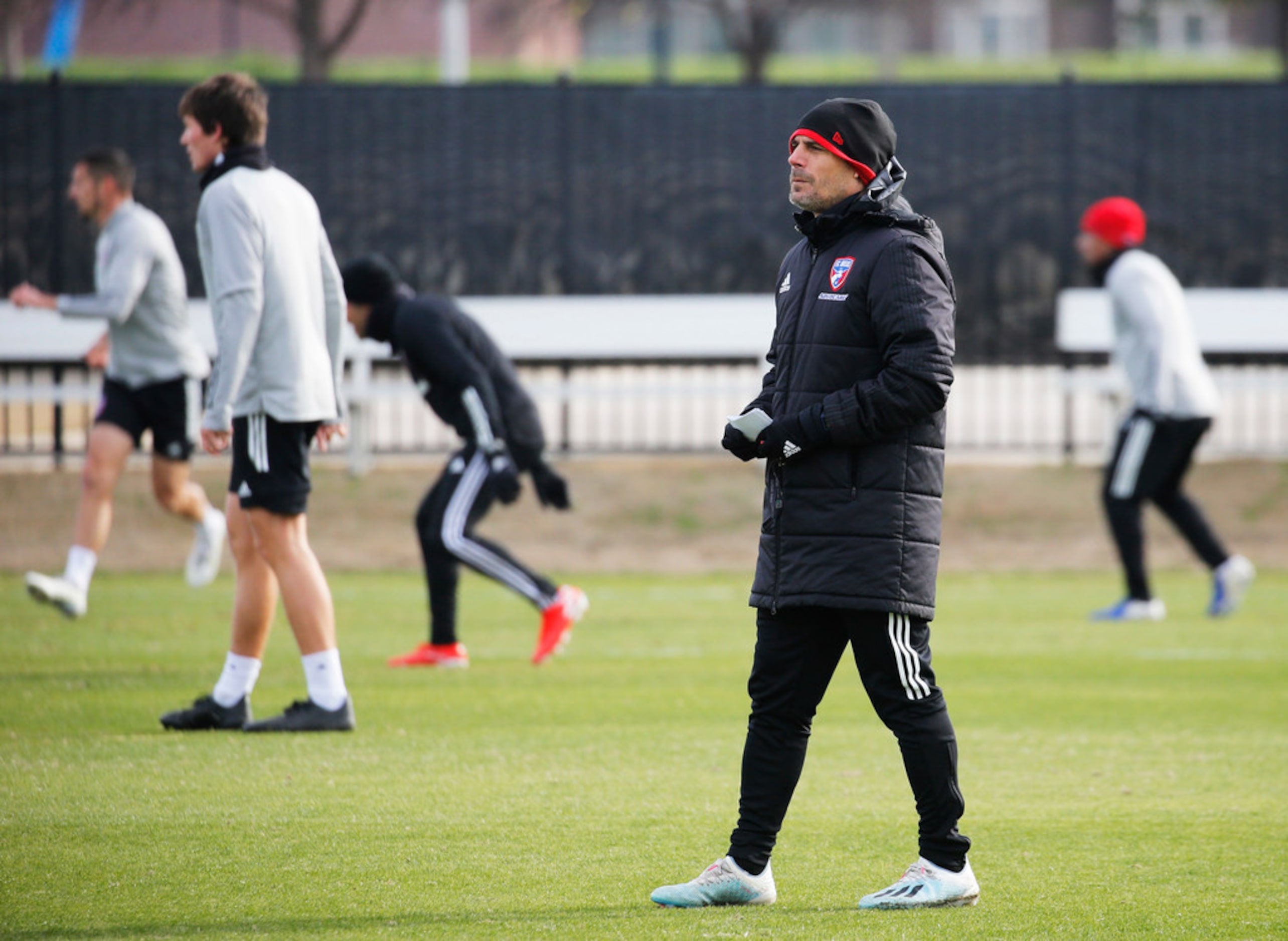 FC Dallas head coach Luchi Gonzalez watches players during the first practice of preseason...