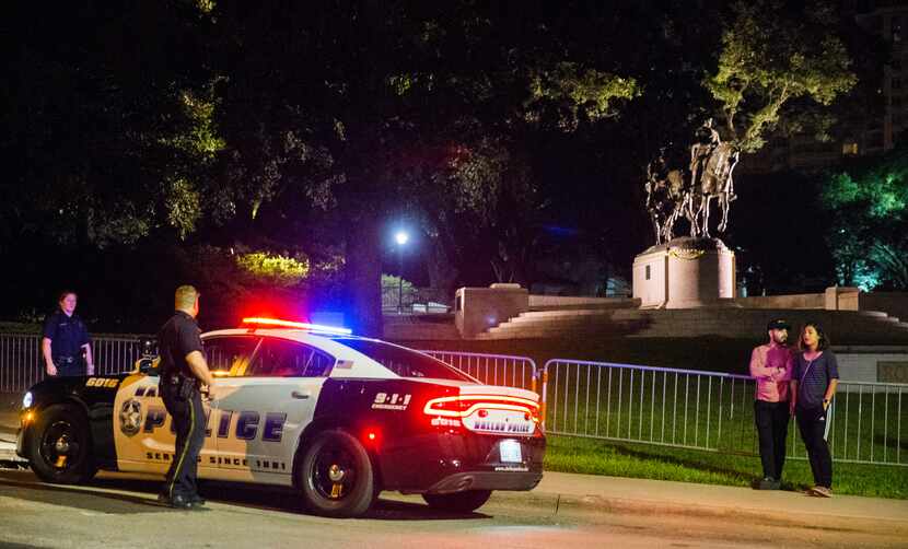 Police officers patrol the area around a statue of Robert E. Lee around 10:30 p.m. on Sept....