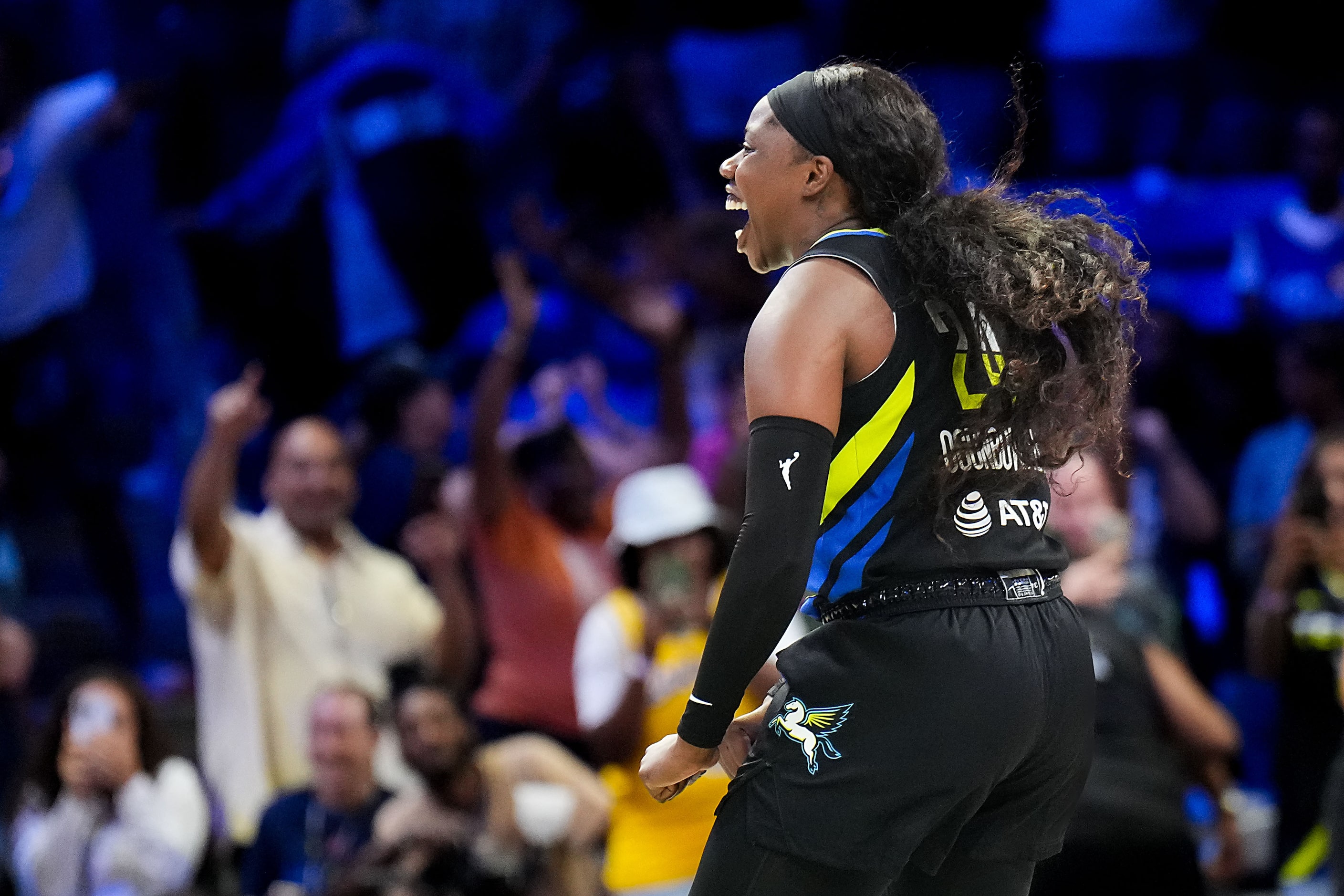 Dallas Wings guard Arike Ogunbowale (24) celebrates after center Teaira McCowan  scored to...