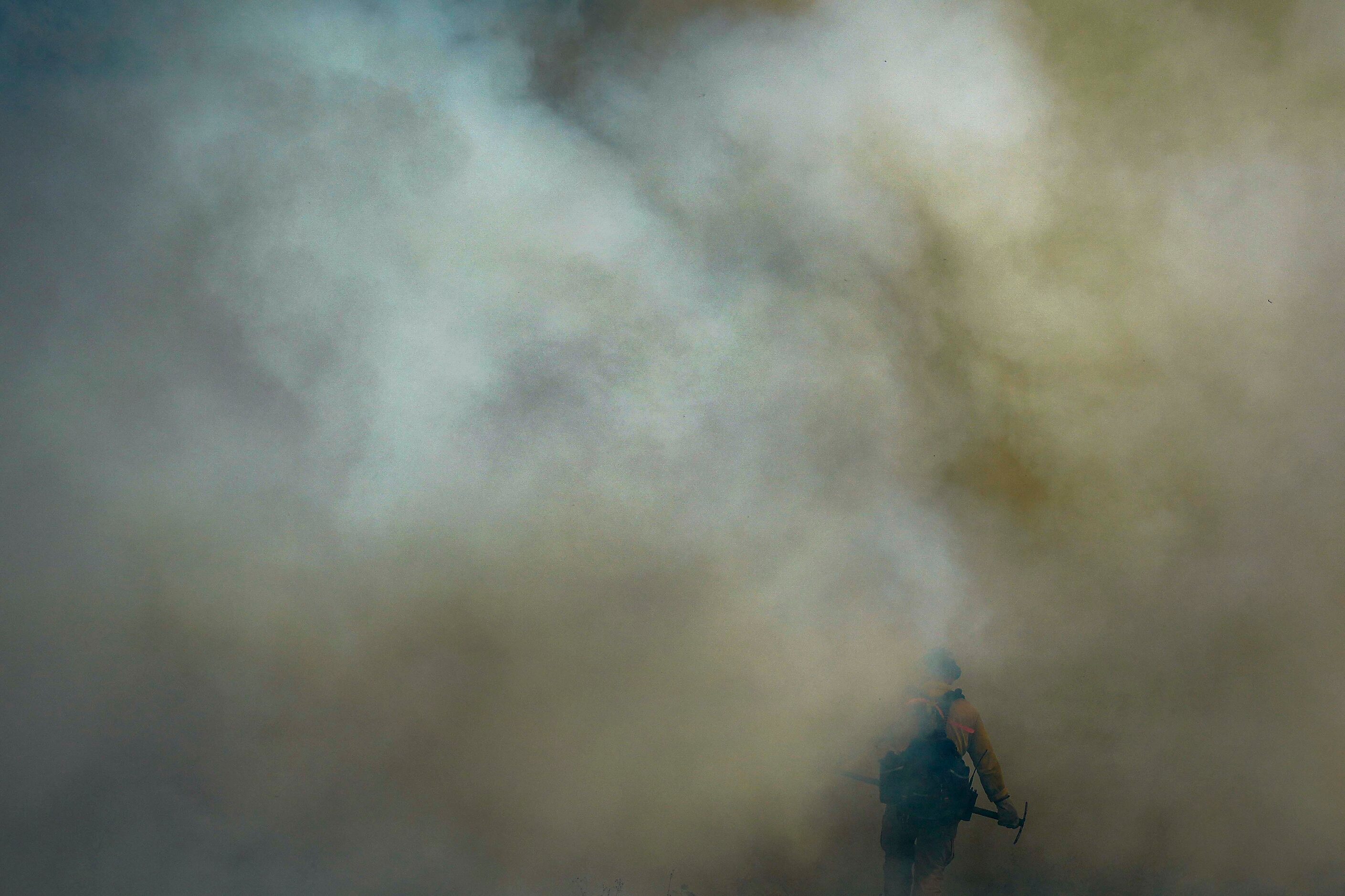 Ronald Deroche of US Fish and Wildlife Service disappears into smoke during a prescribed...