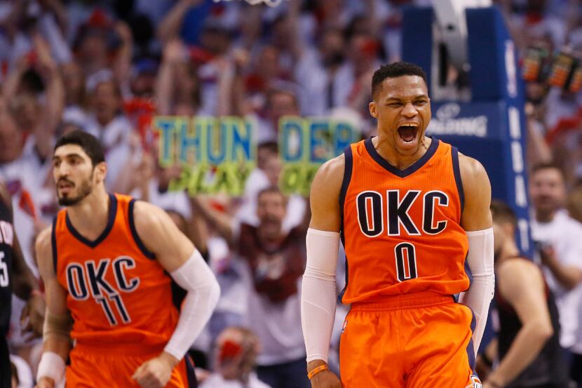 Oklahoma City Thunder guard Russell Westbrook (0) shouts following a dunk by teammate Enes...