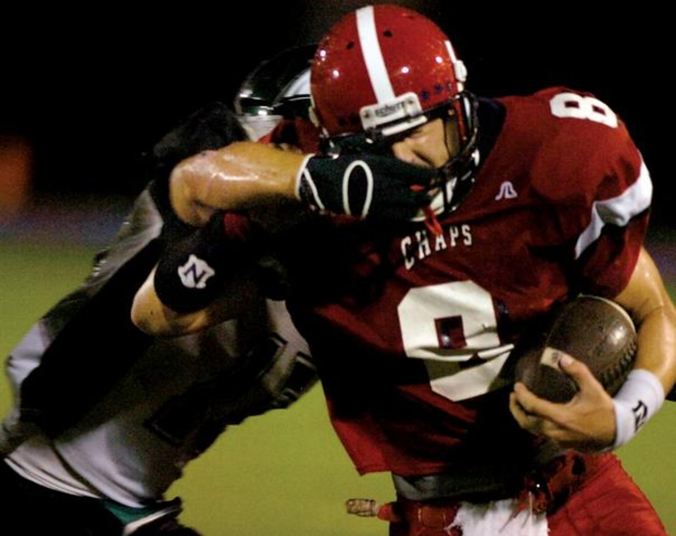 Aubrey's Kaled Parrent (8) fights off a tackle by Paradise cornerback Caleb Reed (15)....