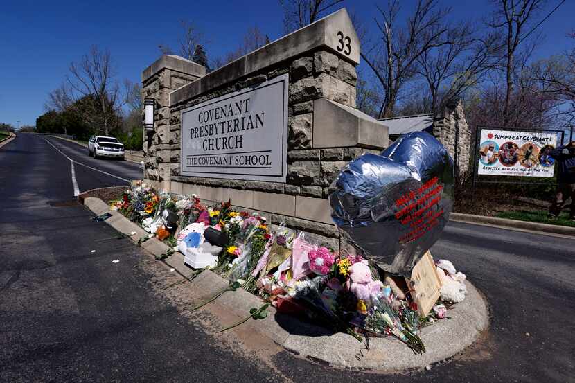 FILE - A balloon with names of the victims is seen at a memorial at the entrance to The...