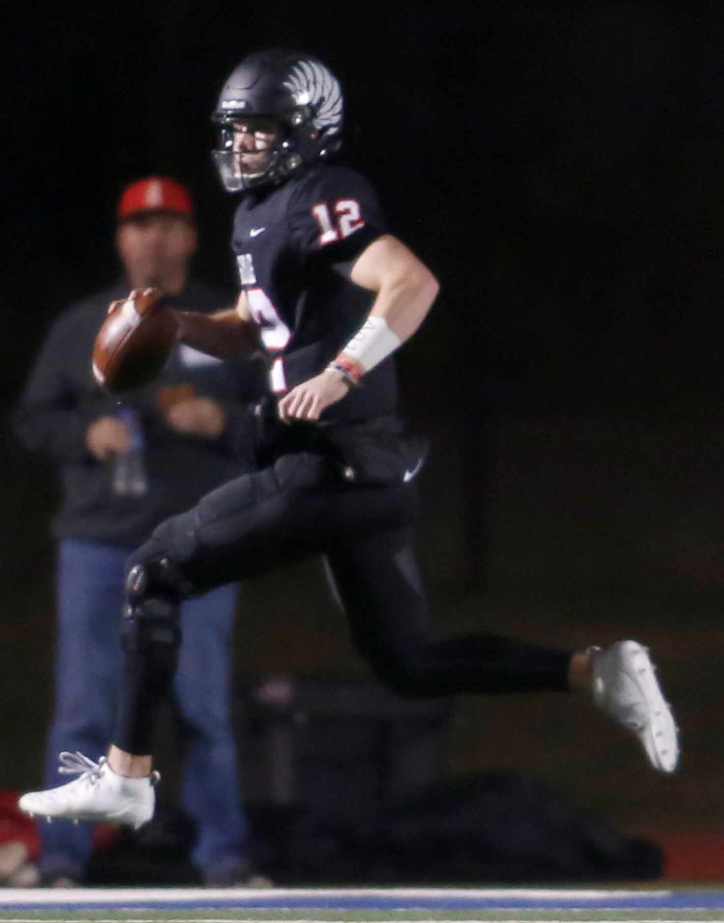 Argyle quarterback C.J. Rogers (12) rolls out of the pocket as he searches for an open...