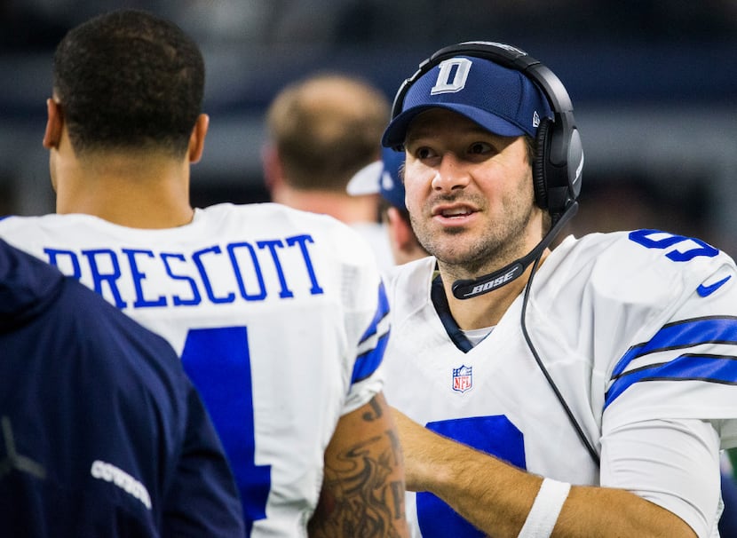 Dallas Cowboys quarterback Dak Prescott (4) talks with quarterback Tony Romo (9) on the...