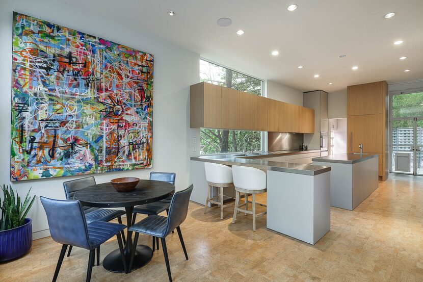 The chic Bulthaup kitchen has a sleek look with white oak cabinetry and stainless steel...