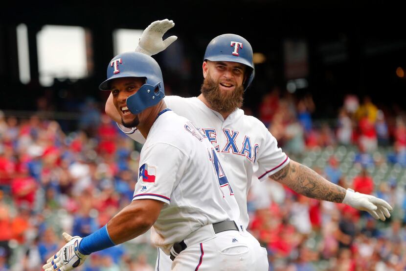 Texas Rangers Carlos Gomez (14) and Mike Napoli (5) celebrate Napoli's second inning home...