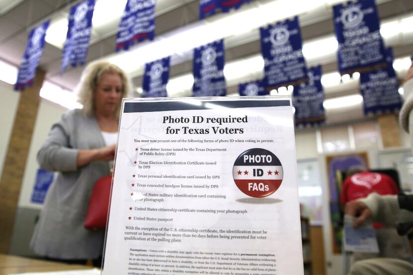 FILE - In this March 1, 2016, file photo, a sign tells voters of voter ID requirements...