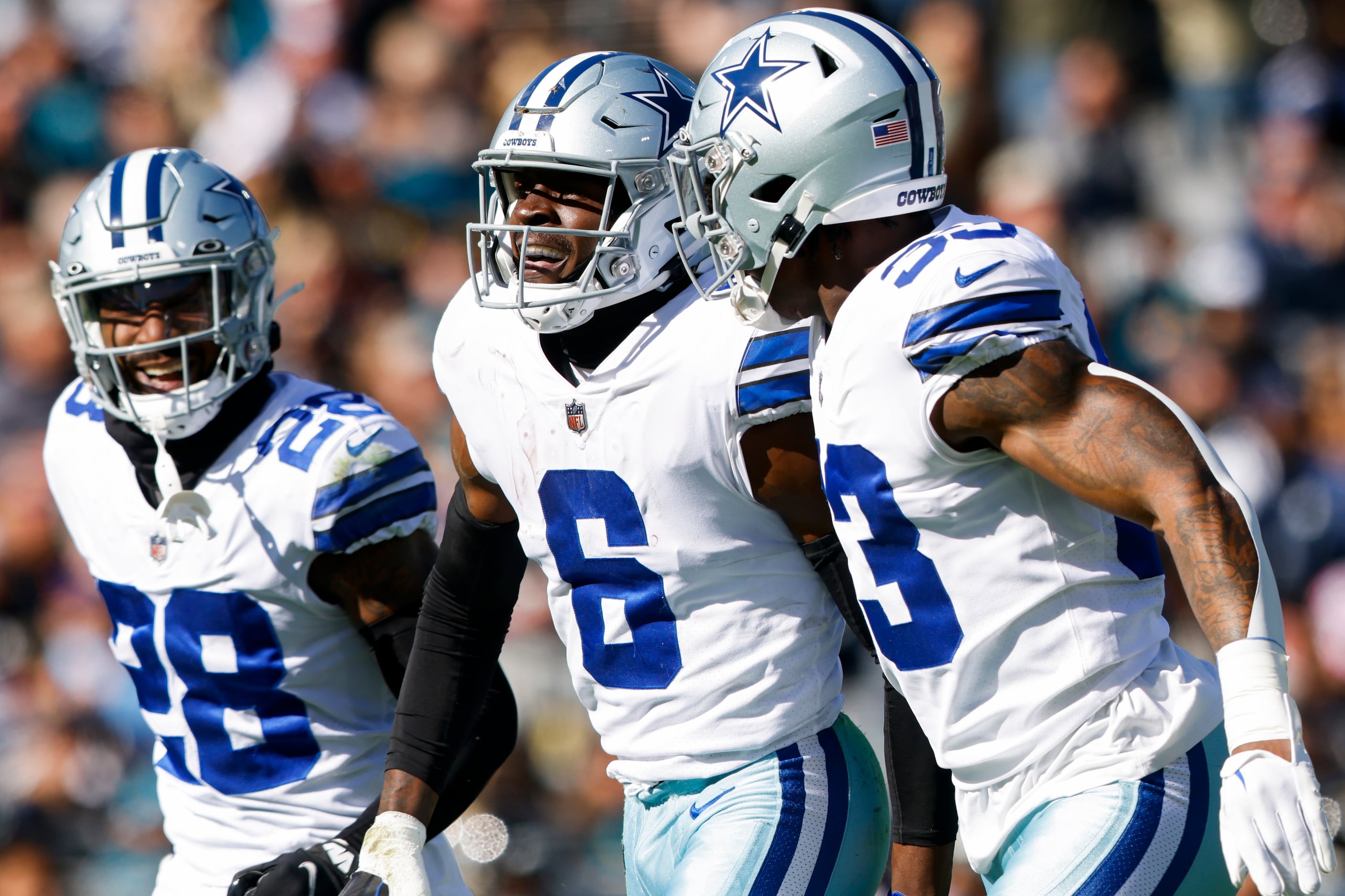 Jayron Kearse of the Dallas Cowboys tackles Trevor Lawrence of the